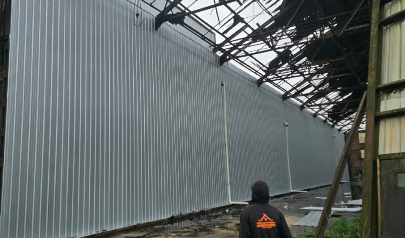 H&H Construction crew installing warehouse metal siding